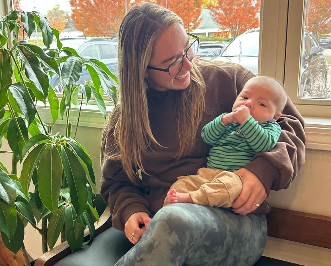 smiling mom holding little baby