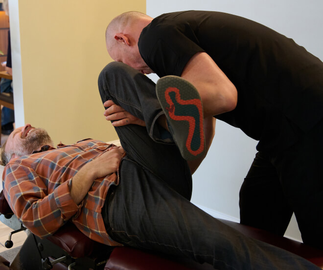 doctor stretching patient's leg