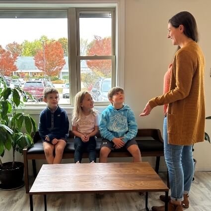 staff talking to group of kids