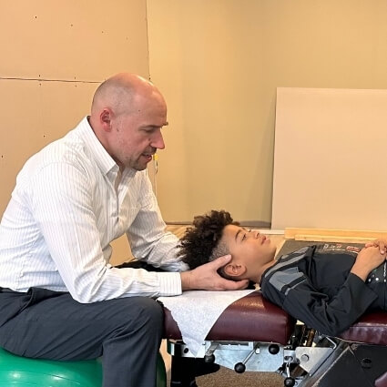 Dr Bart adjusting childs neck