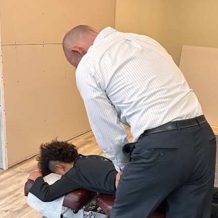 Dr Bart adjusting childs back