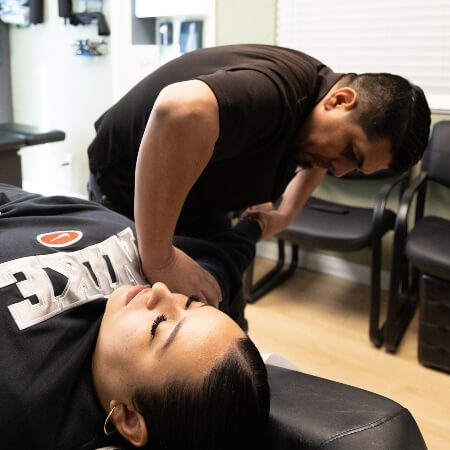 Chiropractor adjusting patient's arm