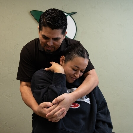 Female patient receiving adjustment from a chiropractor