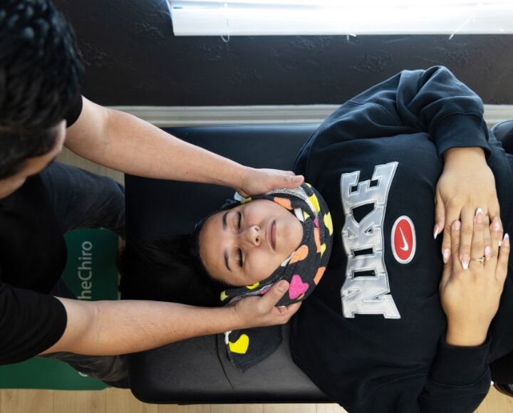 Chino chiropractor adjusting a female patient
