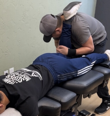 Chiropractor stretching patient's leg