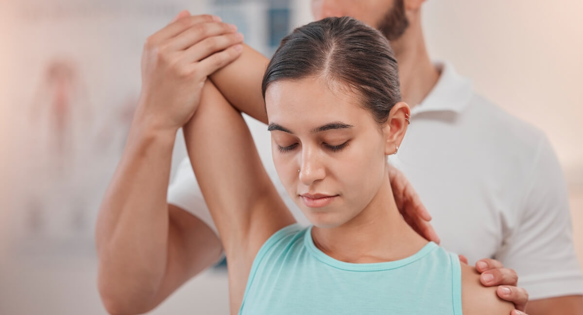 Male chiropractor adjusting a female patient