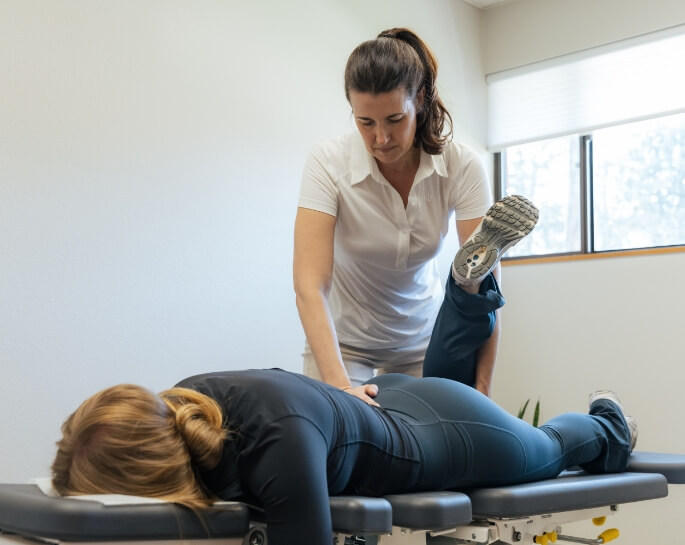 Colorado Springs chiropractor Dr. Jessica adjusting a female patient