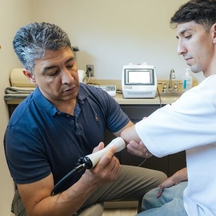 Colorado Springs patient receiving laser therapy on elbow