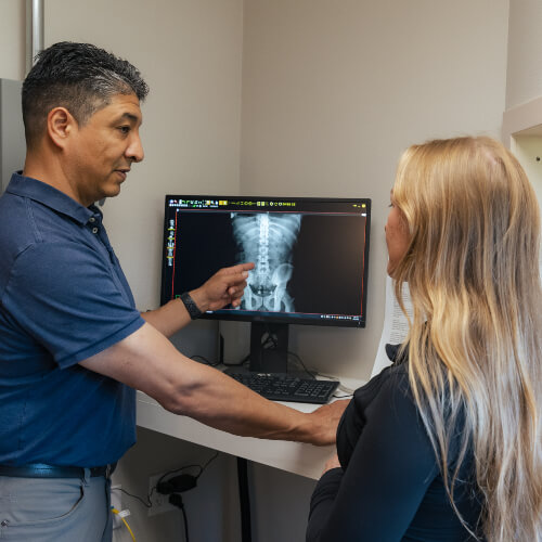 Colorado Springs chiropractor discussing x-rays with patient