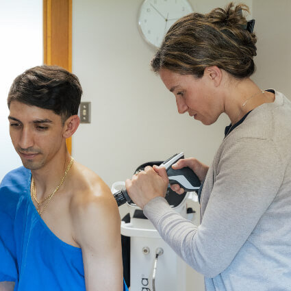 Colorado Springs chiropractor using shockwave therapy to treat patient