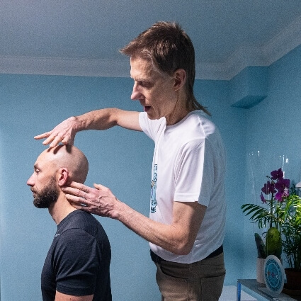 Dr Leom adjusting patients neck