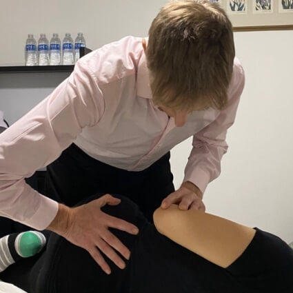 Dr Leom adjusting patients back