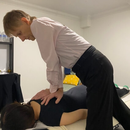 Dr Leom adjusting patients back