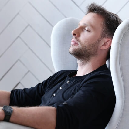man relaxing in an armchair