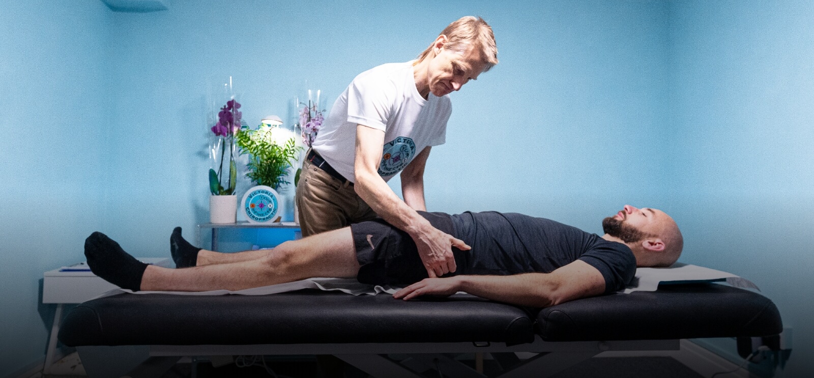 Pimlico chiropractor Dr Leom adjusting patient on a table