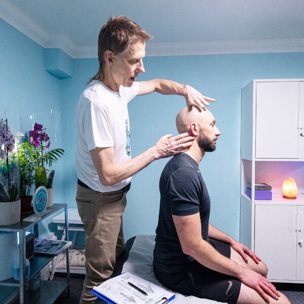 Pimlico chiropractor Dr Leom adjusting practice members neck