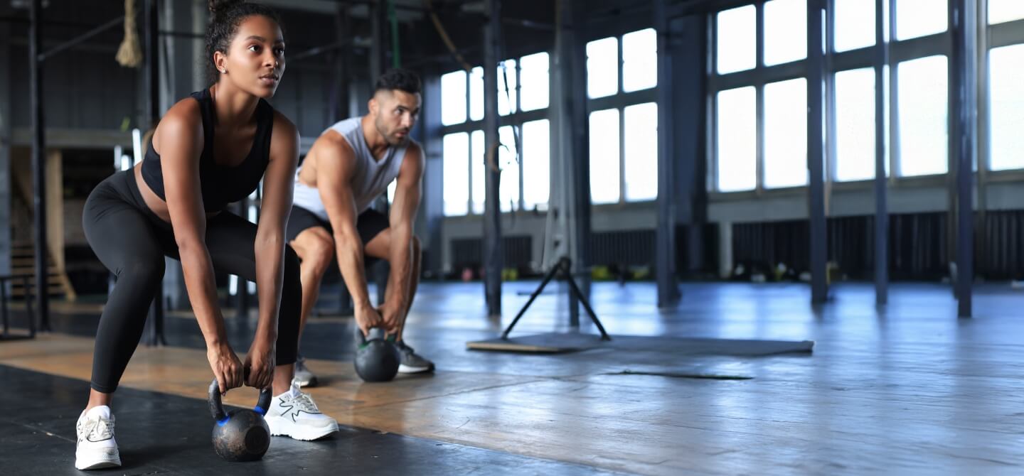 Athletes doing strength straining in gym