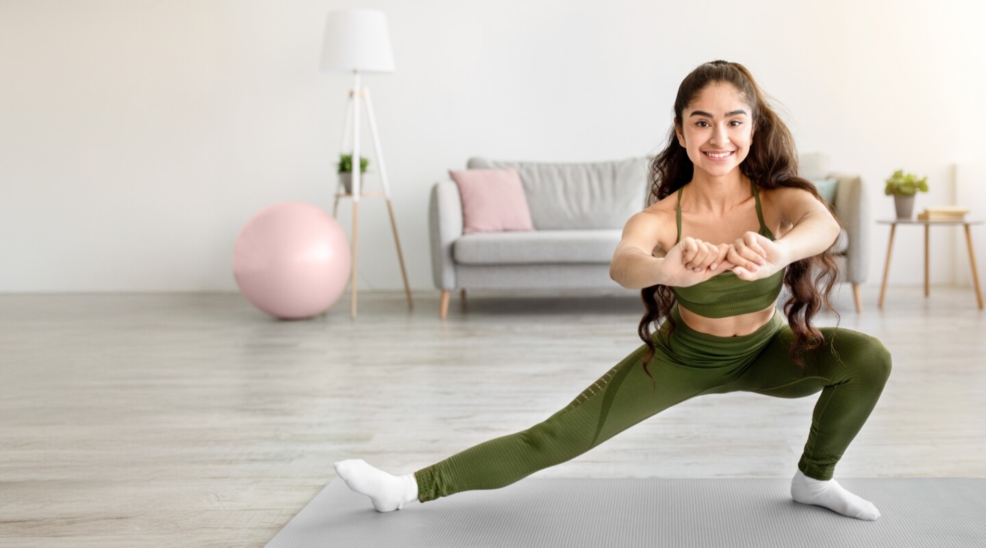 Young woman exercising in her home
