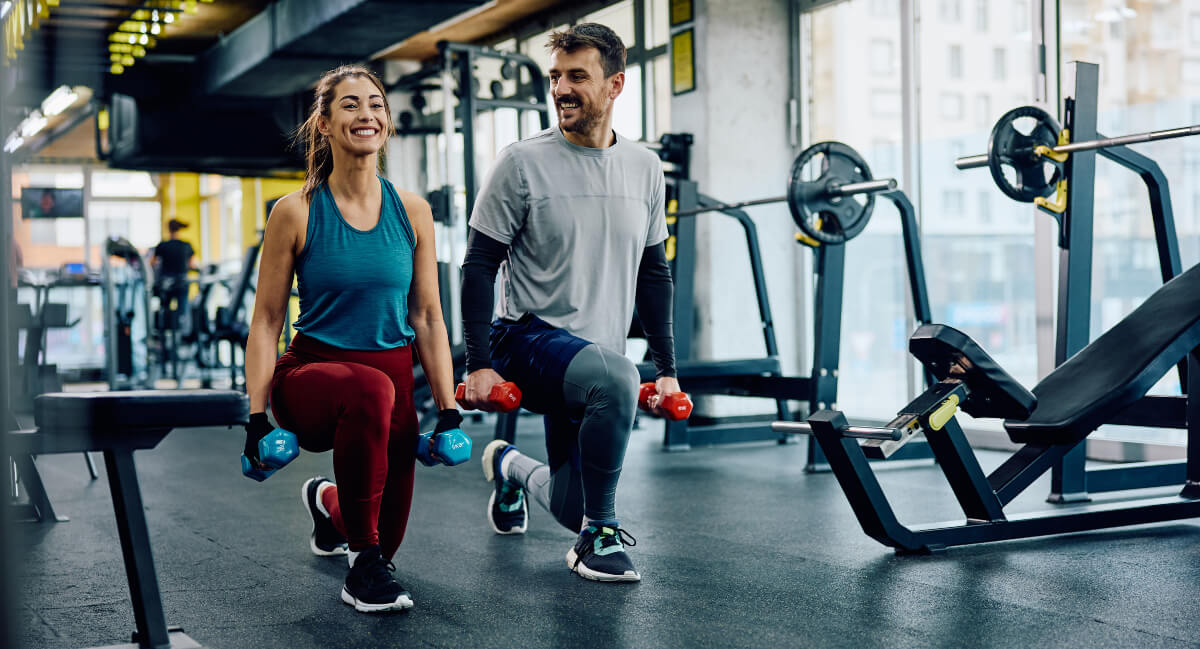Man and woman exercising in gym