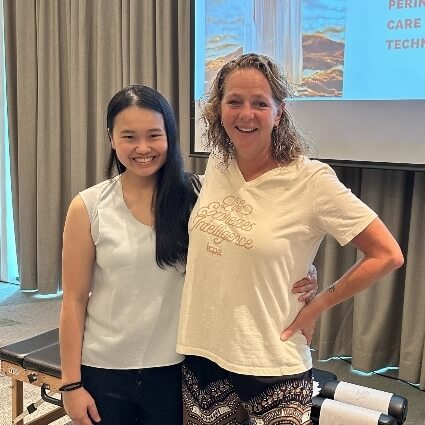 Subang Jaya chiropractor Dr Minji smiling with a patient at an event