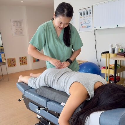 Dr Minji adjusting pregnant patients back