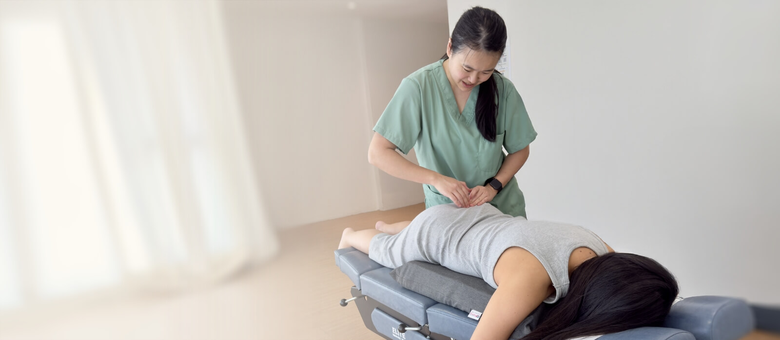 Subang Jaya chiropractor Dr Minji adjusting patients back