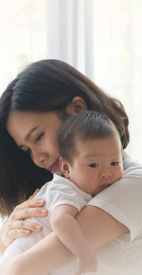 mom holding her baby on her chest