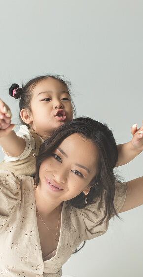 mom playing with her child riding on her back