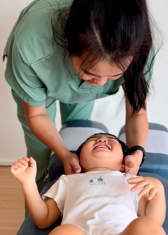 Dr. Minji adjusting smiling child