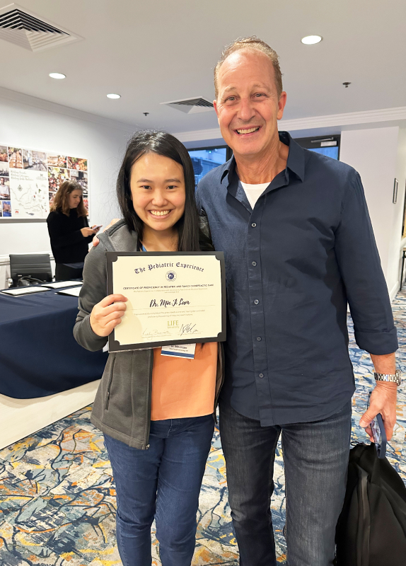 Dr Minji holding certificate
