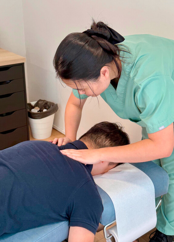 Dr. Minji massaging patients back