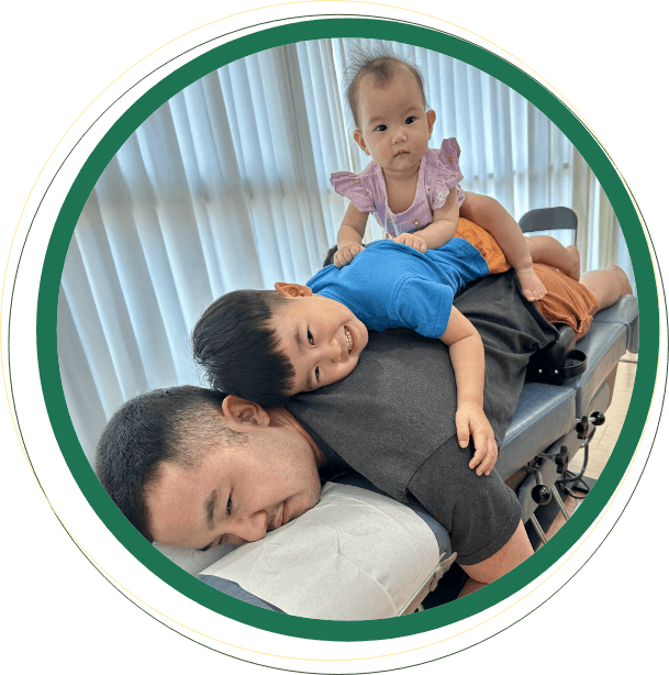 Children laying on dads back at Chirosanctuary