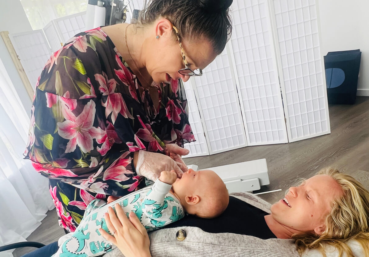 Dr. Paula looking down at baby