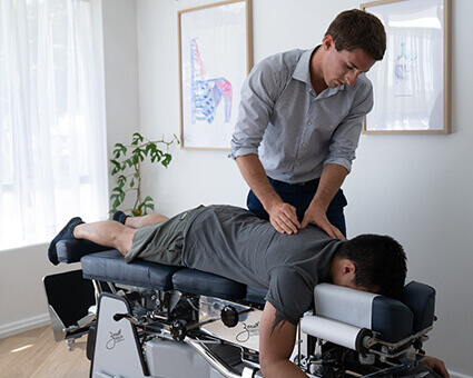 Dr. Ethan adjusting patient on table