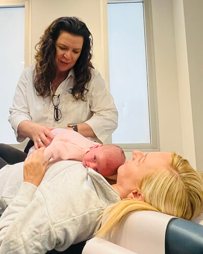 Adjusting baby on mom