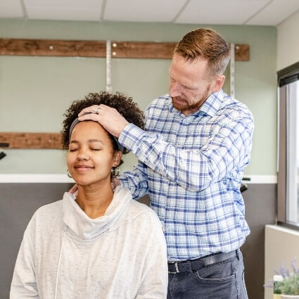 Dr John adjusting patients neck