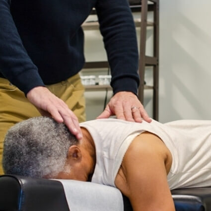 Dr John adjusting patients neck