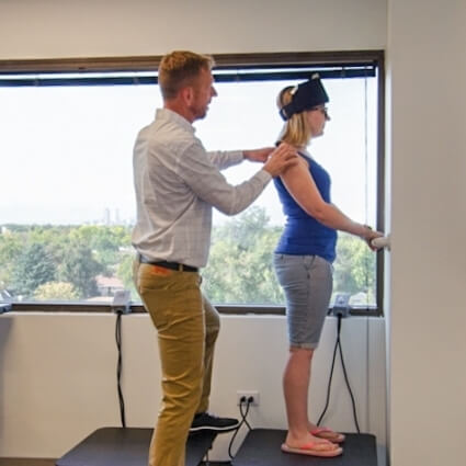 Dr John helping patient standing on a table