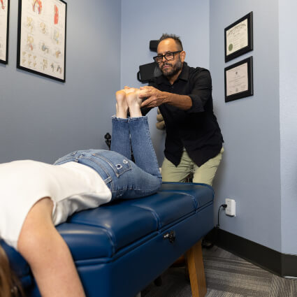 Austin chiropractor stretching patient's leg