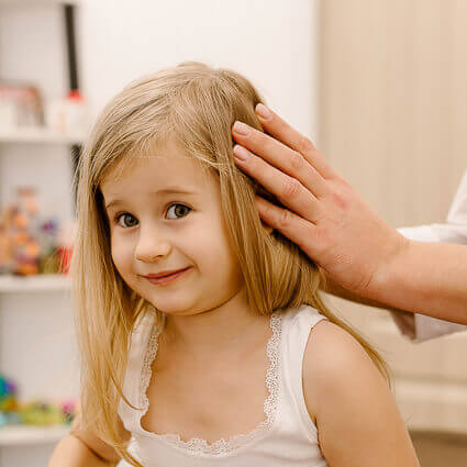 girl looking amused during neck adjustment