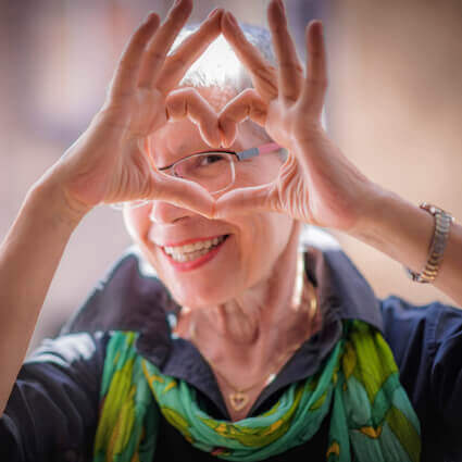 women with her hands shaped as a heart