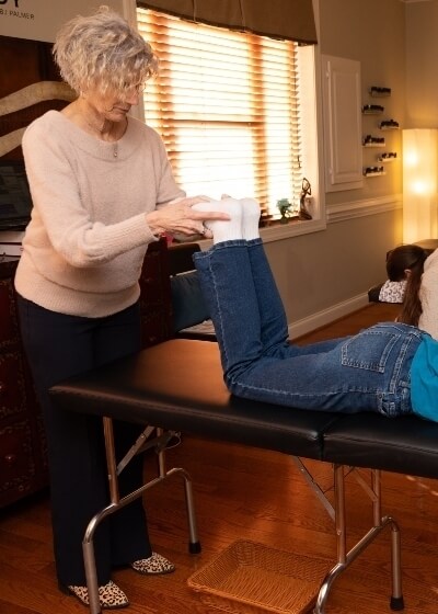 Dr Ginni examining patients legs