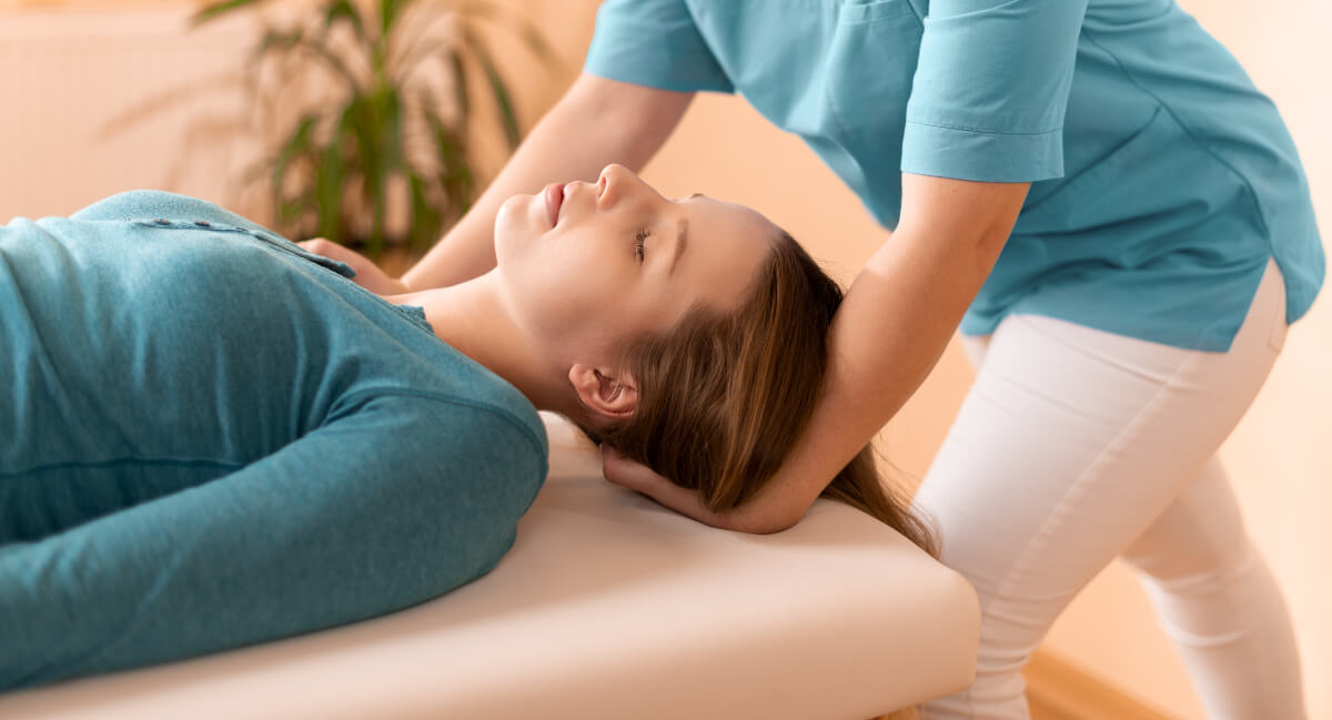 Chiropractor adjusting a female patient