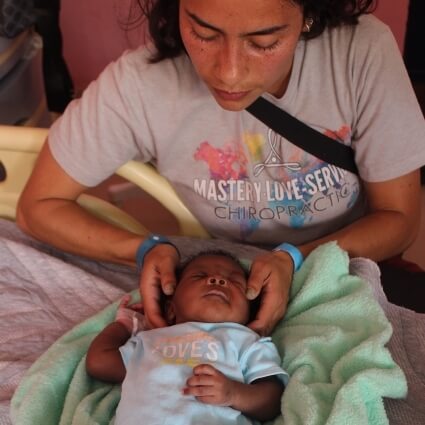 Baby receiving a chiropractic adjustment