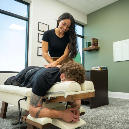 Female patient receiving a chiropractic neck adjustment