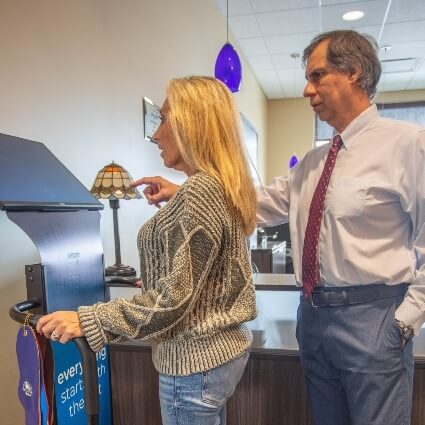 Dr Gavric assisting patient with a foot scan