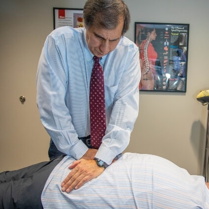 Dr Gavric adjusting patients back