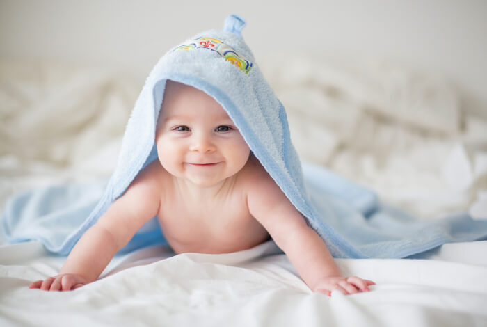 baby on their stomach laying on a blanket