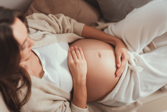 pregnant woman with her hands on her stomach