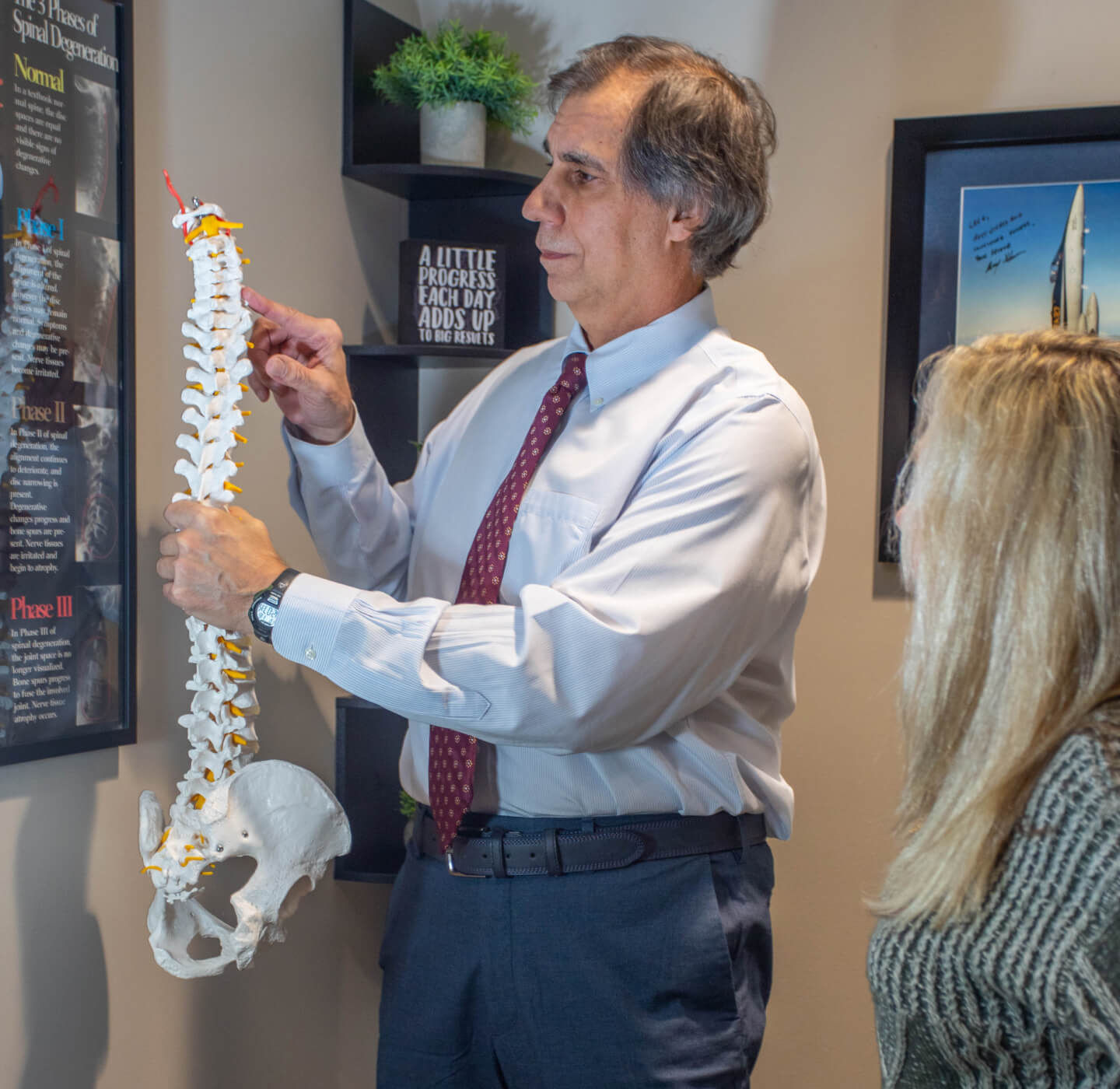 Dr. Gavric explaining chiropractic care to a patient at his Oak Creek clinic